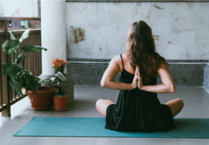 Women holding reverse prayer yoga pose