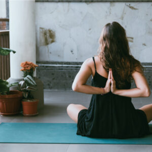 Women holding reverse prayer yoga pose