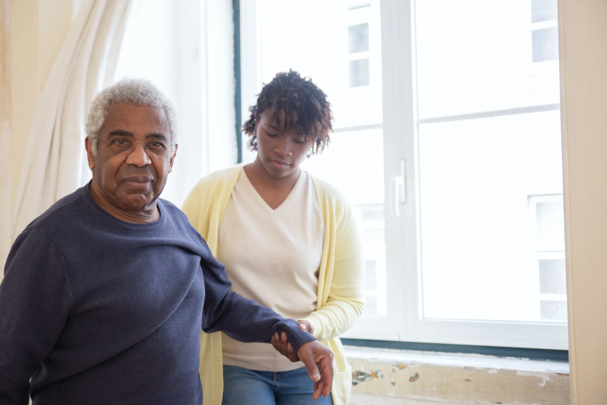 Woman helping older man with his arm. caregivers need good care too