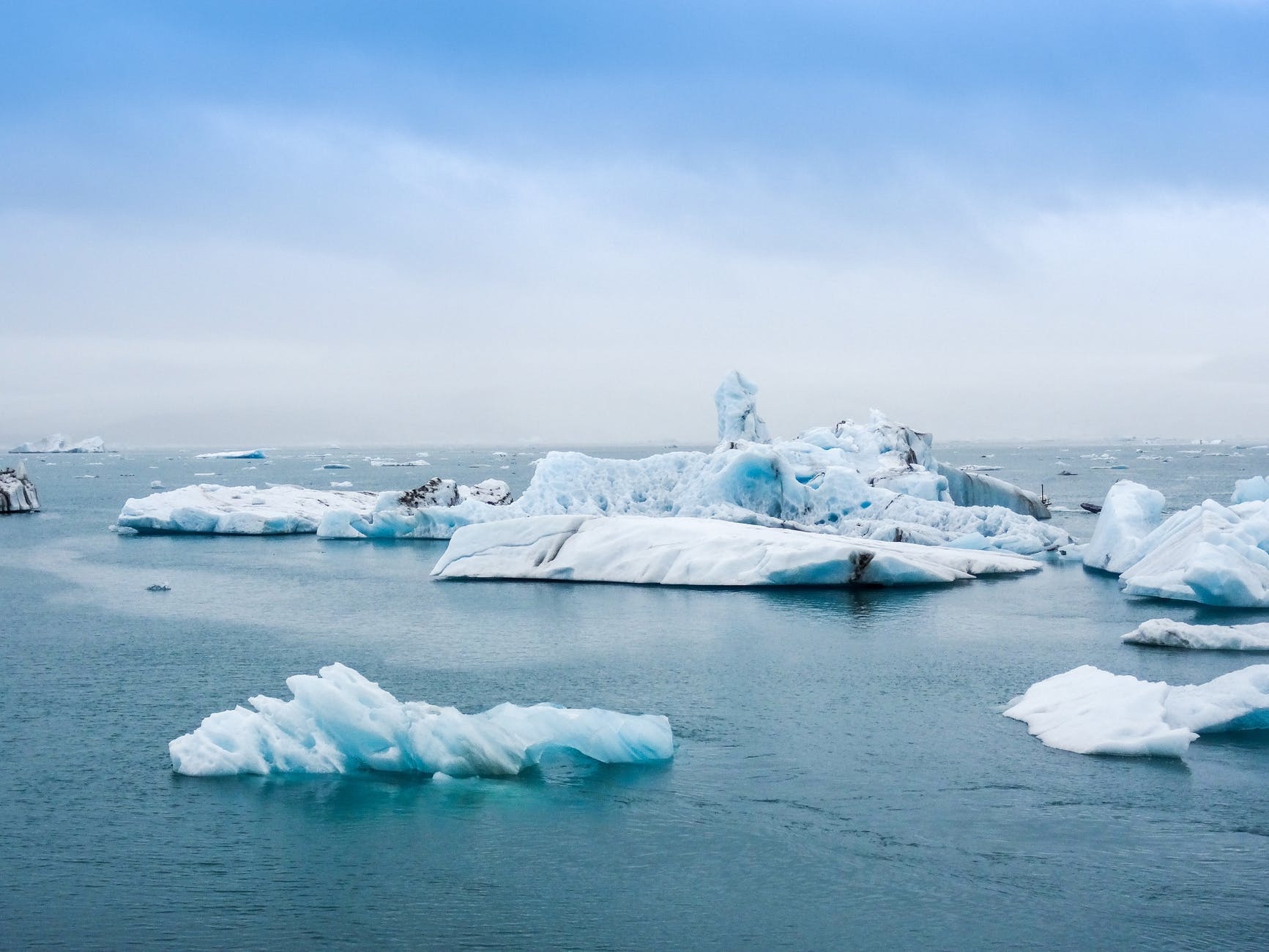 Icebergs in ocaean with dirt on them. image1