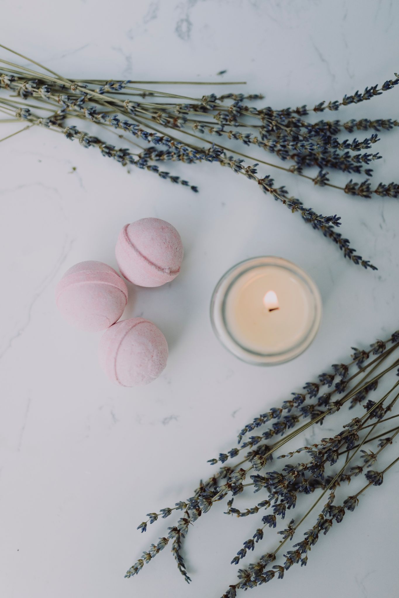 bath bombs and lit candle with lavender