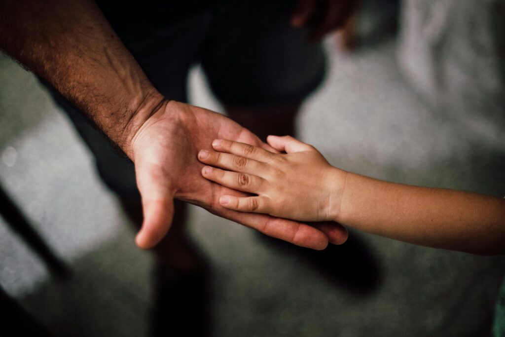 father and child hands pexels juanpphotoandvideo 1250452 copy