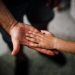 father and child hands pexels juanpphotoandvideo 1250452 copy